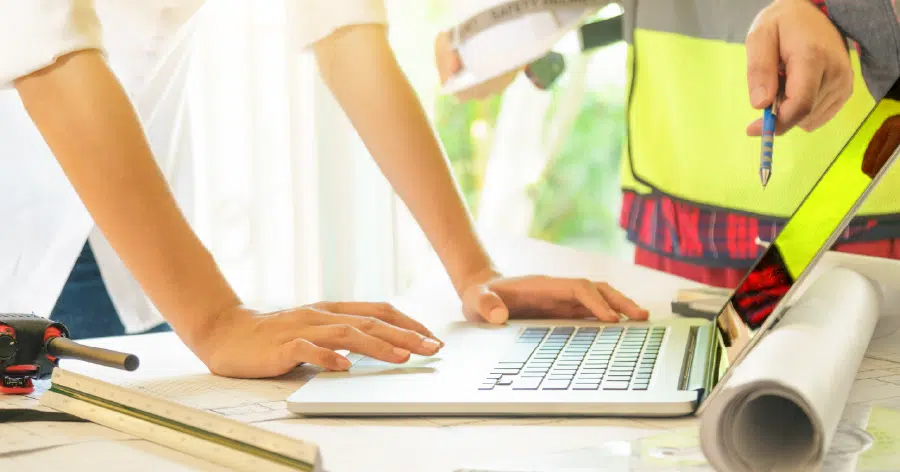 An image of two people working with construction estimating software that integrates with QuickBooks.