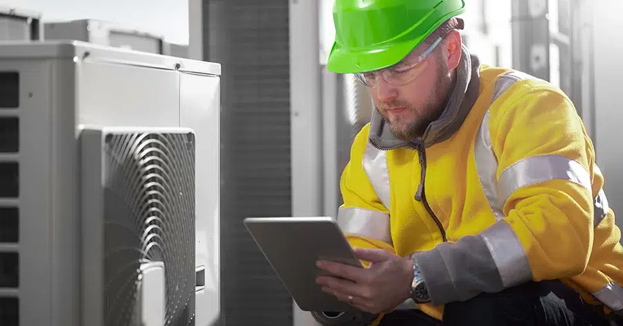 Male construction worker reviewing project management software.