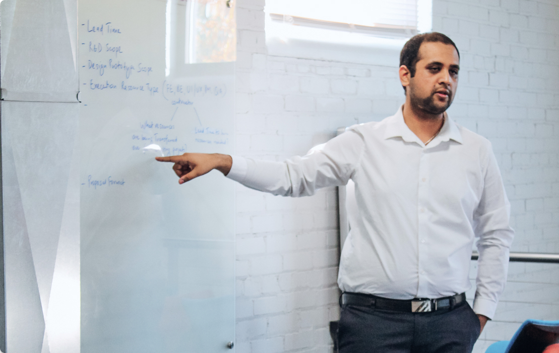 Employee presenting at a whiteboard